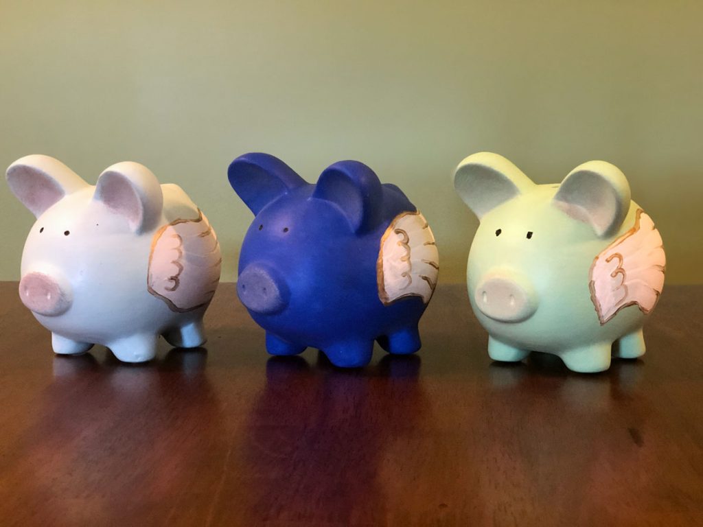 Hand-painted piggy banks created by girl scouts for Vahnne